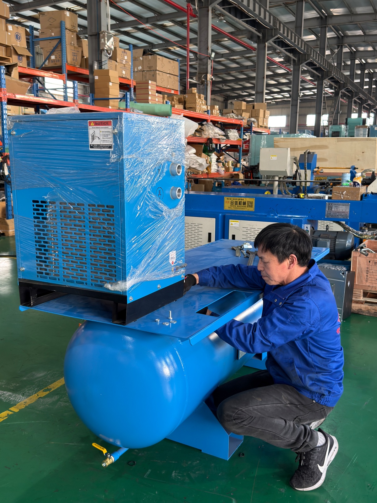 Workers assembling air compressors